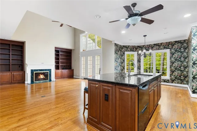 a kitchen with stainless steel appliances granite countertop a sink and a wooden floors