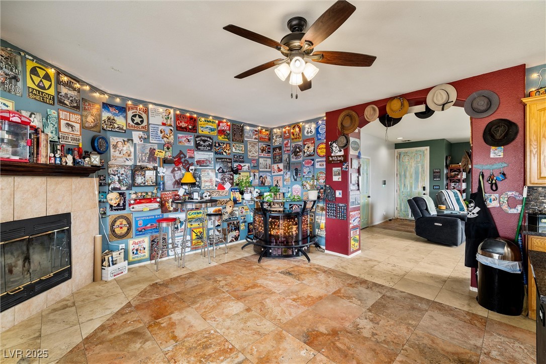 1131 South Blagg Road Pahrump, NV 89048 - Photo 15 of 30 Miscellaneous room featuring a fireplace and a ceiling fan