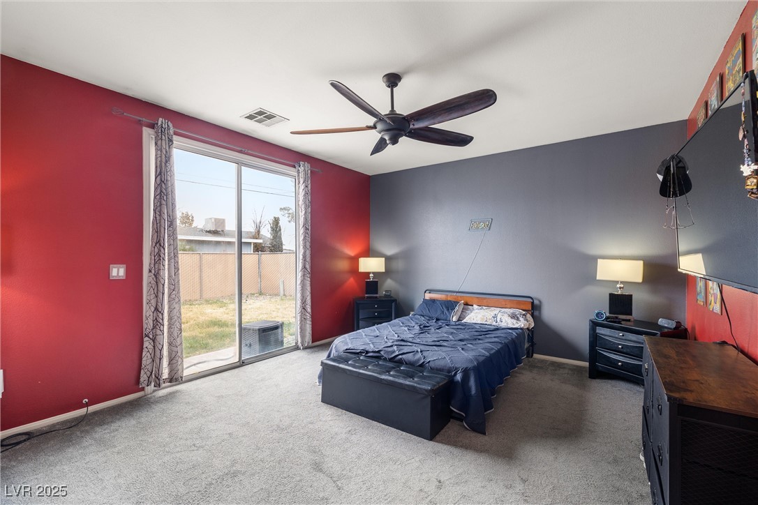 1131 South Blagg Road Pahrump, NV 89048 - Photo 16 of 30 Bedroom with baseboards, carpet flooring, access to exterior, and visible vents