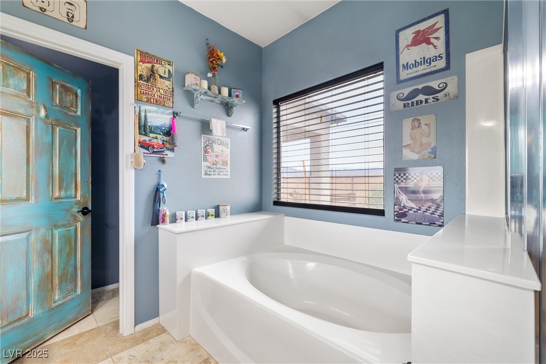 1131 South Blagg Road Pahrump, NV 89048 - Photo 19 of 30 Full bath featuring a garden tub, baseboards, and tile patterned floors