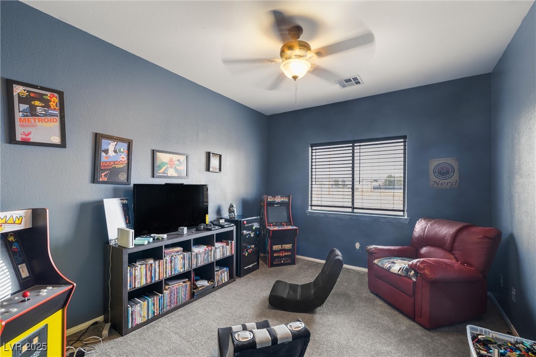 1131 South Blagg Road Pahrump, NV 89048 - Photo 21 of 30 Living room featuring carpet, baseboards, ceiling fan, and visible vents