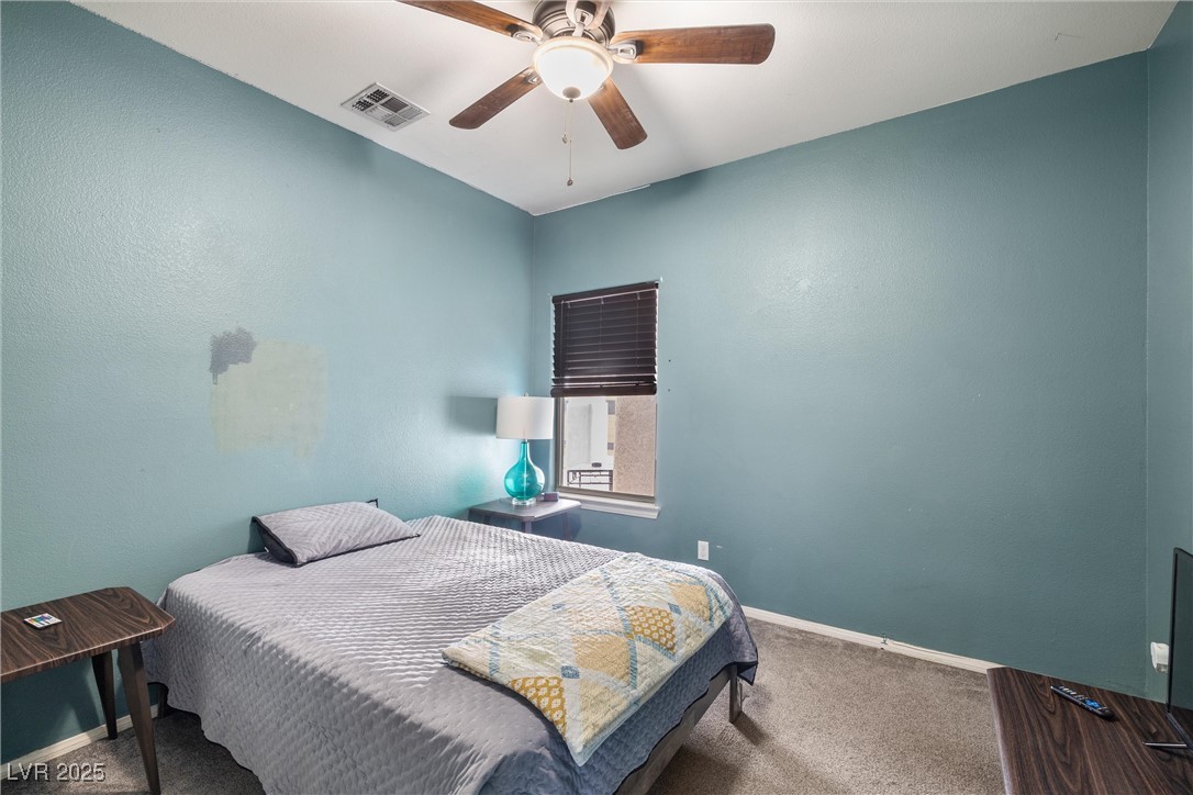 1131 South Blagg Road Pahrump, NV 89048 - Photo 23 of 30 Carpeted bedroom with a ceiling fan, baseboards, and visible vents