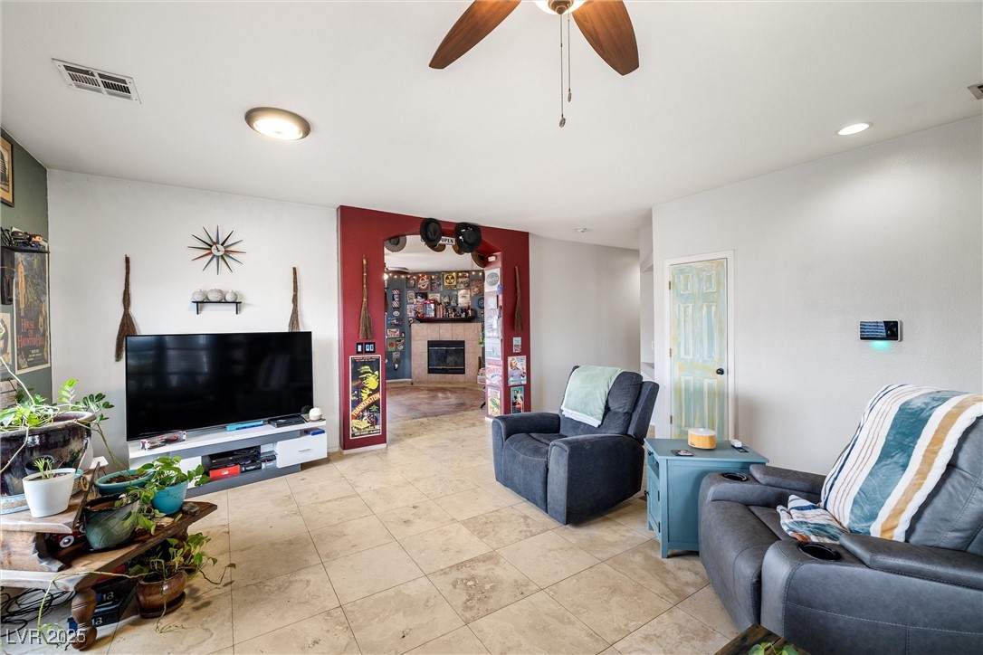 1131 South Blagg Road Pahrump, NV 89048 - Photo 7 of 30 Living room with recessed lighting, a glass covered fireplace, ceiling fan, and visible vents