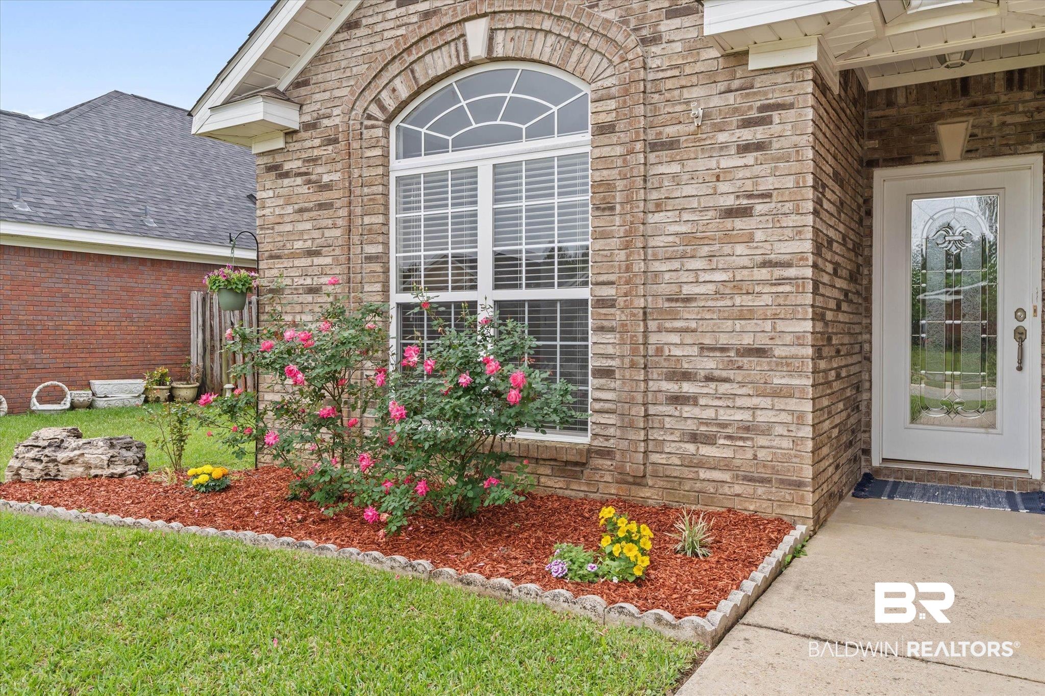 1003 Weatherby Street South Saraland, AL 36571 - Photo 4 of 31 Entrance to property featuring brick siding, a shingled roof, and a yard