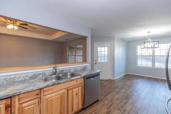 a bathroom with a granite countertop sink and mirror