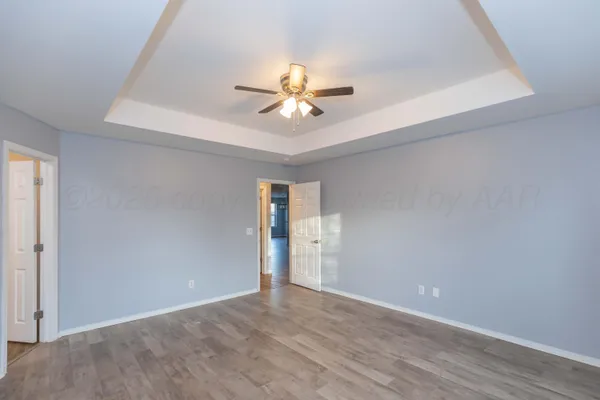 an empty room and chandelier fan