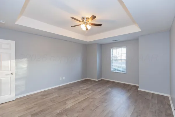 a view of a livingroom with a ceiling fan and window