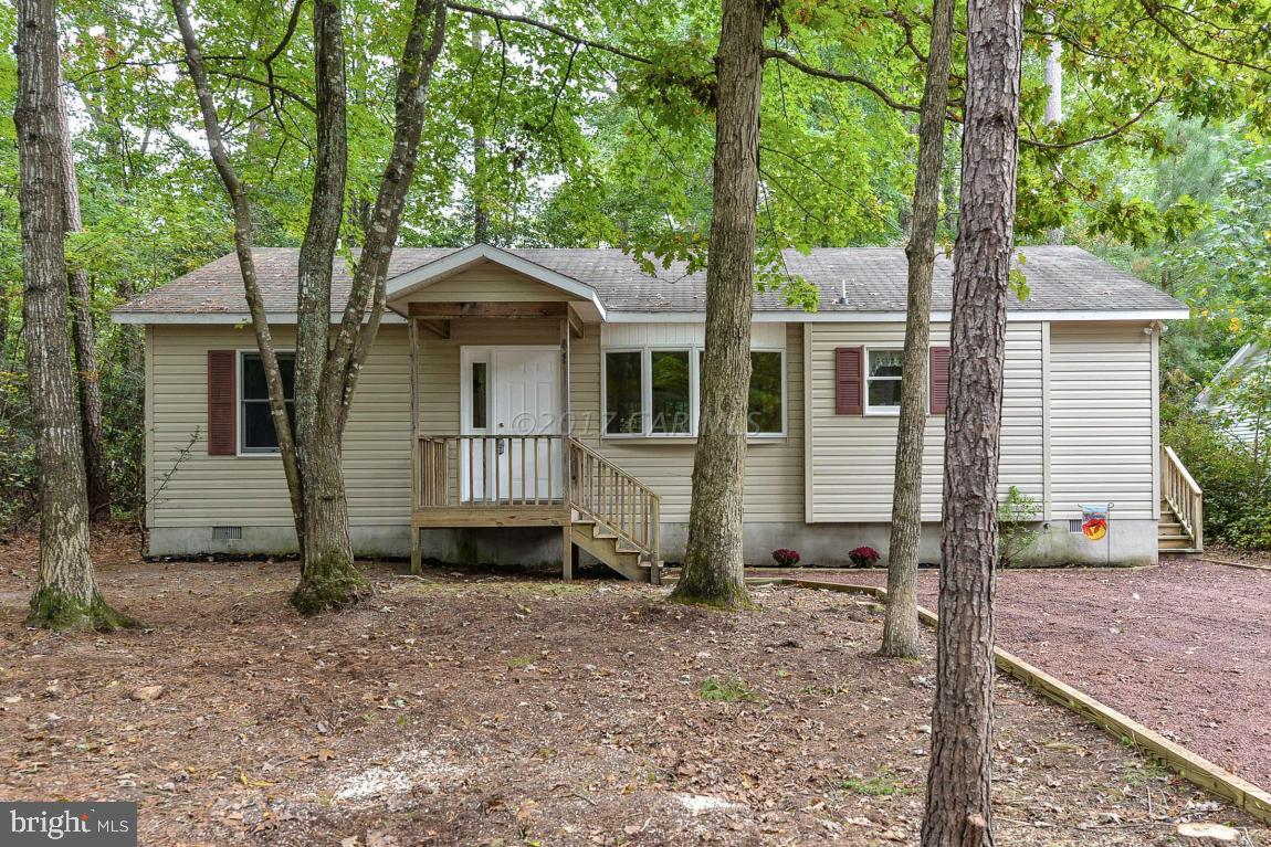 41 Sandyhook Road Ocean Pines, MD 21811 - Photo 1 of 21 a view of a small house with a tree in the yard