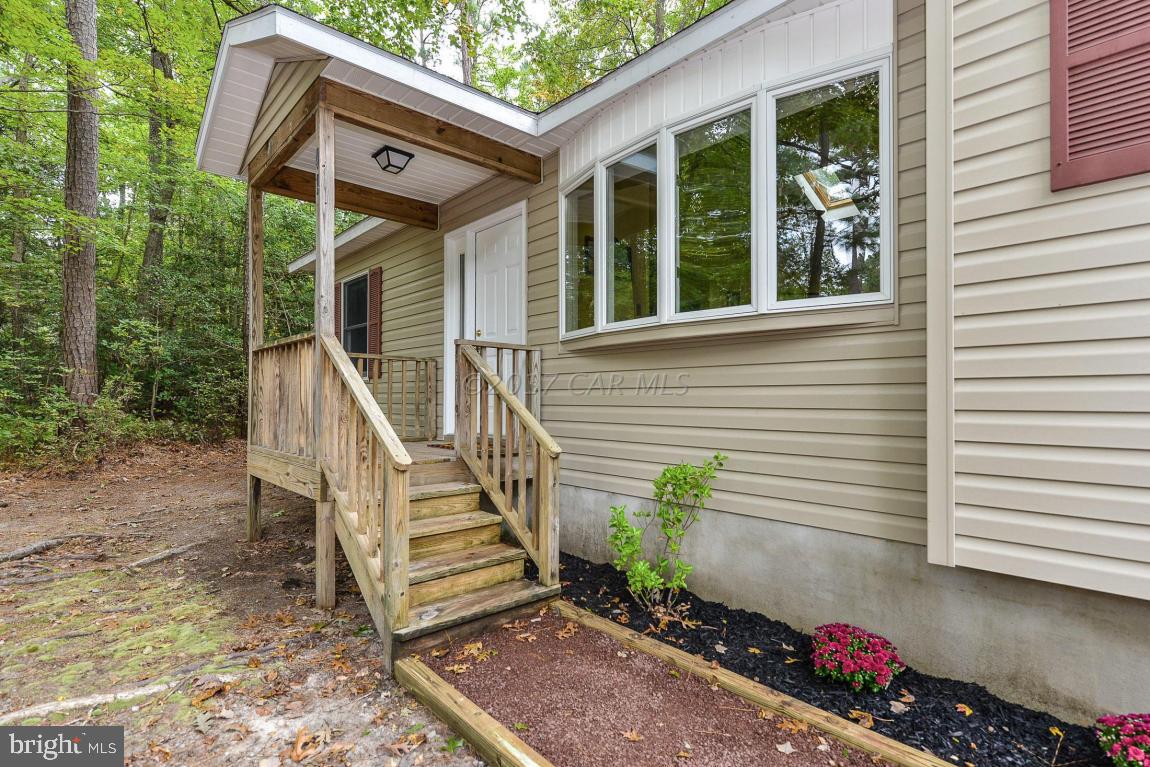 41 Sandyhook Road Ocean Pines, MD 21811 - Photo 20 of 21 a view of a house with two chairs and a table in a patio