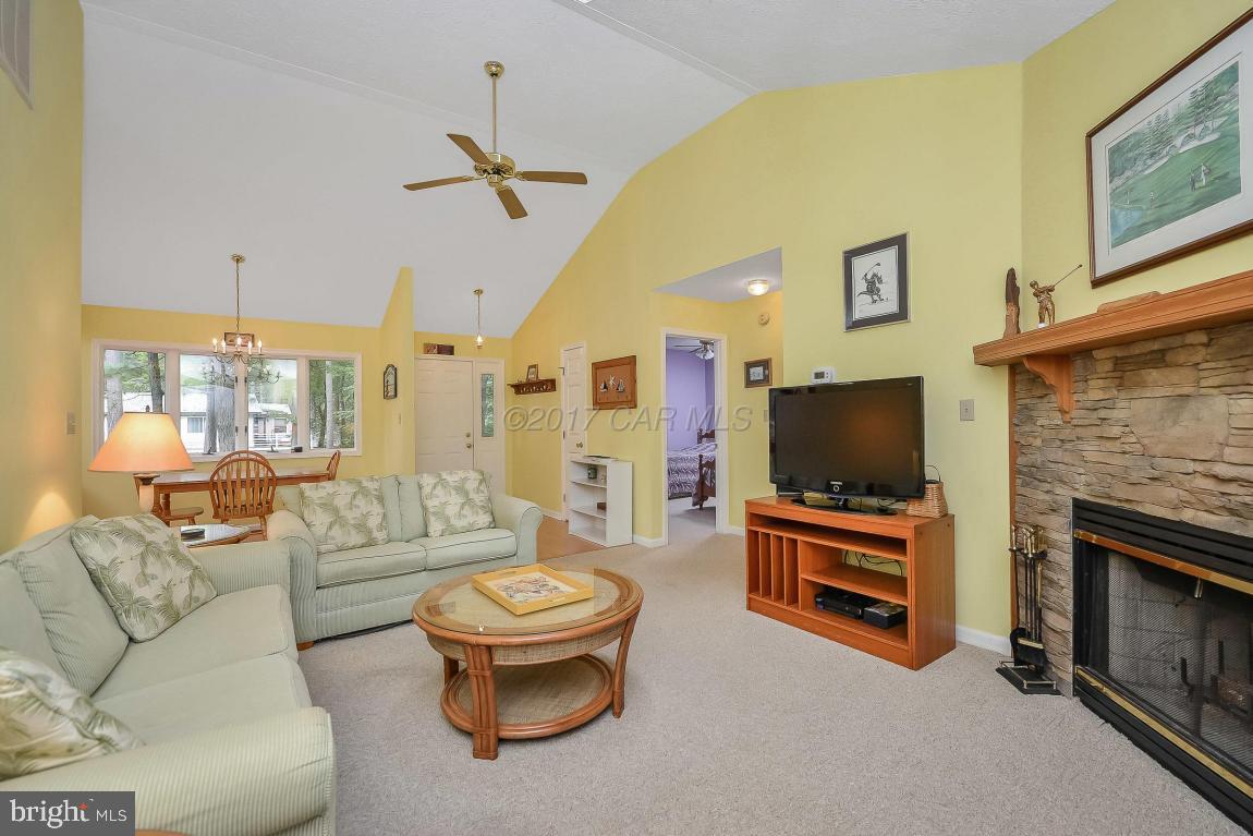 41 Sandyhook Road Ocean Pines, MD 21811 - Photo 4 of 21 a living room with furniture a flat screen tv and a fireplace