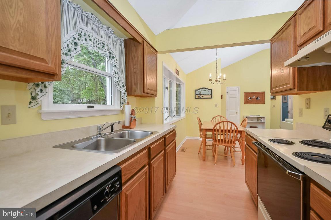 41 Sandyhook Road Ocean Pines, MD 21811 - Photo 6 of 21 a kitchen with wooden cabinets and sink
