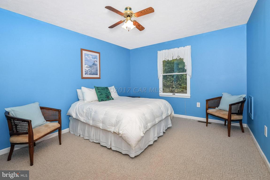 41 Sandyhook Road Ocean Pines, MD 21811 - Photo 9 of 21 a bedroom with a bed a chair and a window