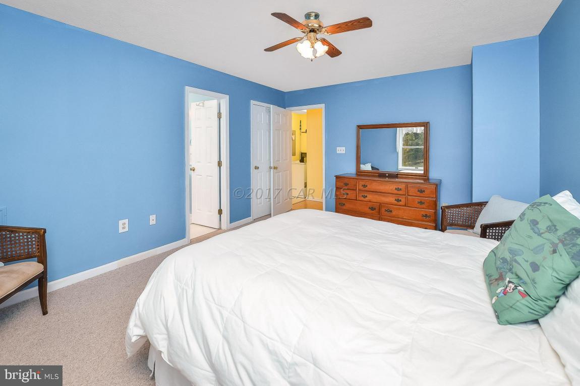 41 Sandyhook Road Ocean Pines, MD 21811 - Photo 10 of 21 a bedroom with a large bed and a chandelier