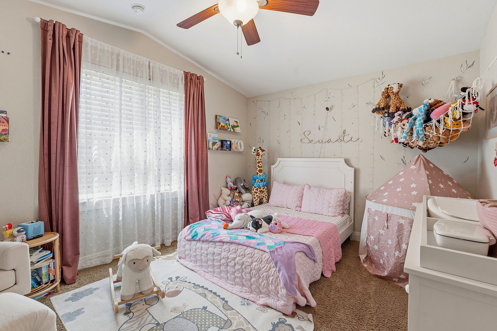 15317 Falconhead Grove Loop Austin, TX 78738 - Photo 22 of 36 Neutral-toned walls featuring an accent wall with subtle leaf motifs