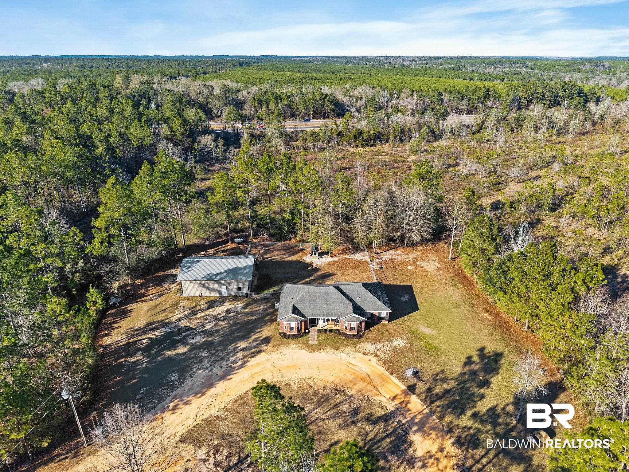 55750 Lottie Road Perdido, AL 36562 - Photo 23 of 84 Aerial view of property and surrounding area featuring a heavily wooded area
