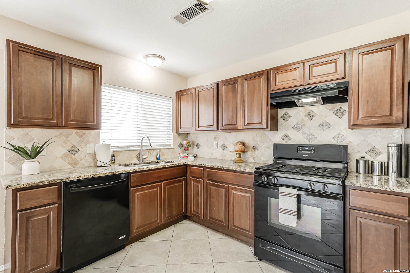 112 Friendswood Path Universal City, TX 78148 - Photo 13 of 31 a kitchen with stainless steel appliances granite countertop a sink stove and cabinets