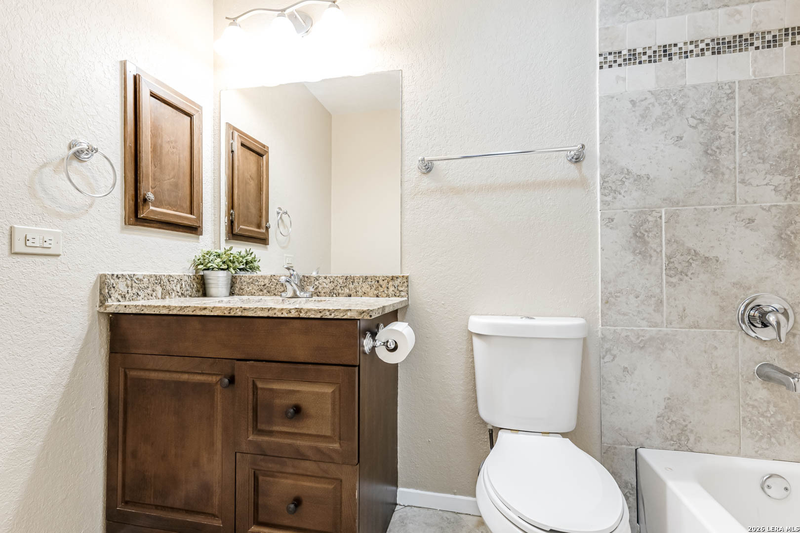 112 Friendswood Path Universal City, TX 78148 - Photo 18 of 31 a bathroom with a toilet a sink and mirror