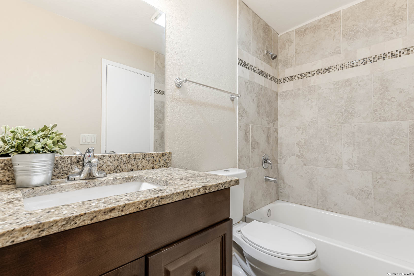 112 Friendswood Path Universal City, TX 78148 - Photo 19 of 31 a bathroom with a granite countertop sink a toilet and shower
