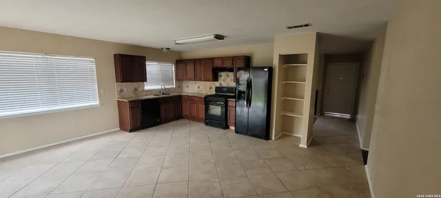 a large kitchen with cabinets and stainless steel appliances