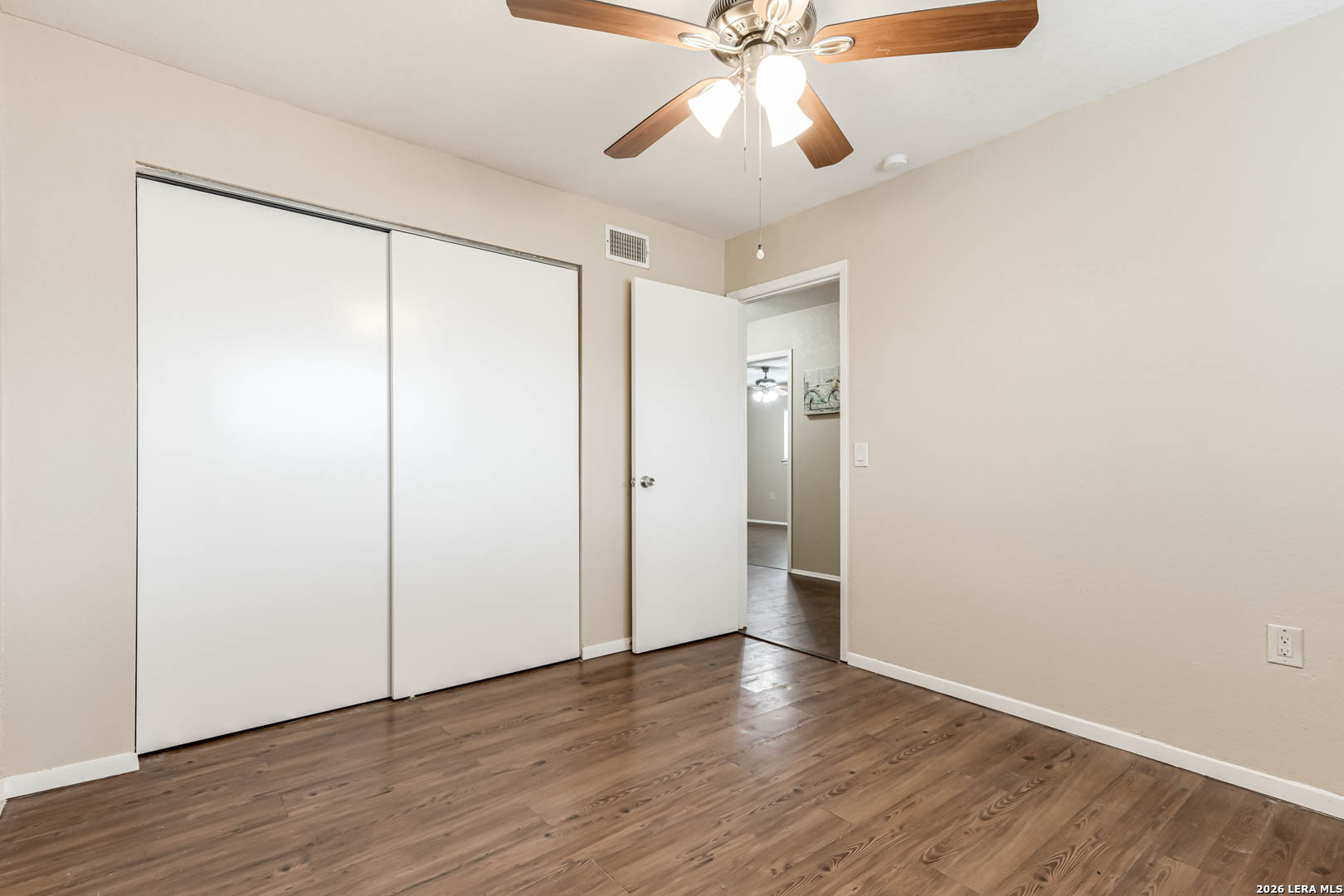 112 Friendswood Path Universal City, TX 78148 - Photo 21 of 31 an empty room with wooden floor closet and fan