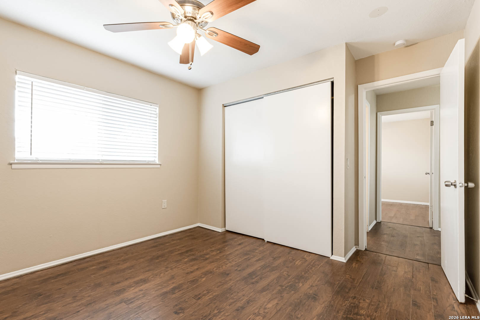 112 Friendswood Path Universal City, TX 78148 - Photo 23 of 31 a view of an empty room with wooden floor and a window