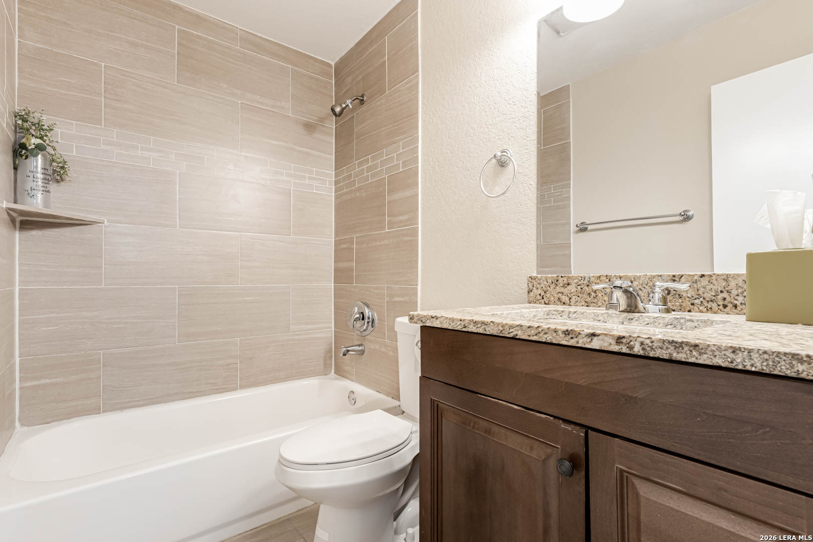 112 Friendswood Path Universal City, TX 78148 - Photo 24 of 31 a bathroom with a granite countertop bathtub sink vanity mirror and toilet