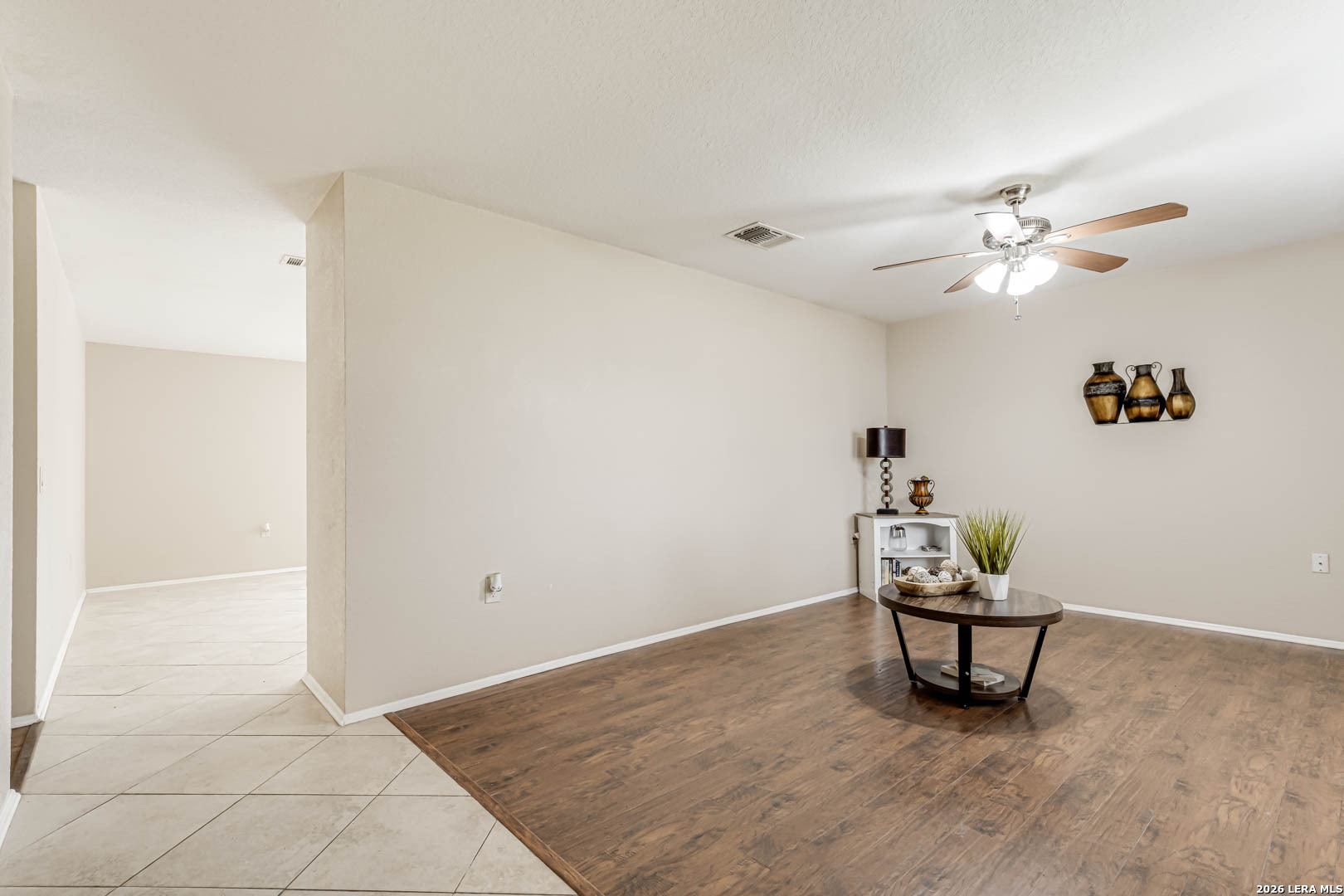 112 Friendswood Path Universal City, TX 78148 - Photo 6 of 31 a view of a livingroom with wooden floor and a ceiling fan