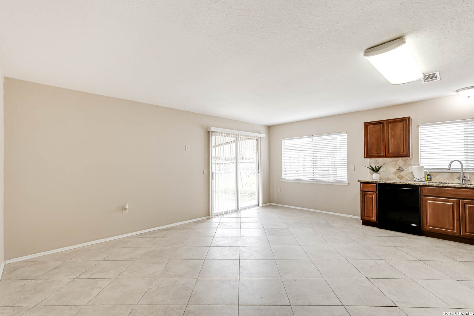112 Friendswood Path Universal City, TX 78148 - Photo 7 of 31 a large white kitchen with a sink and a stove top oven