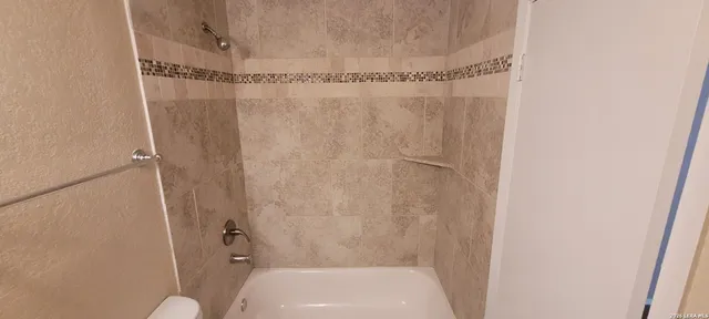 a bathroom with a shower and a toilet