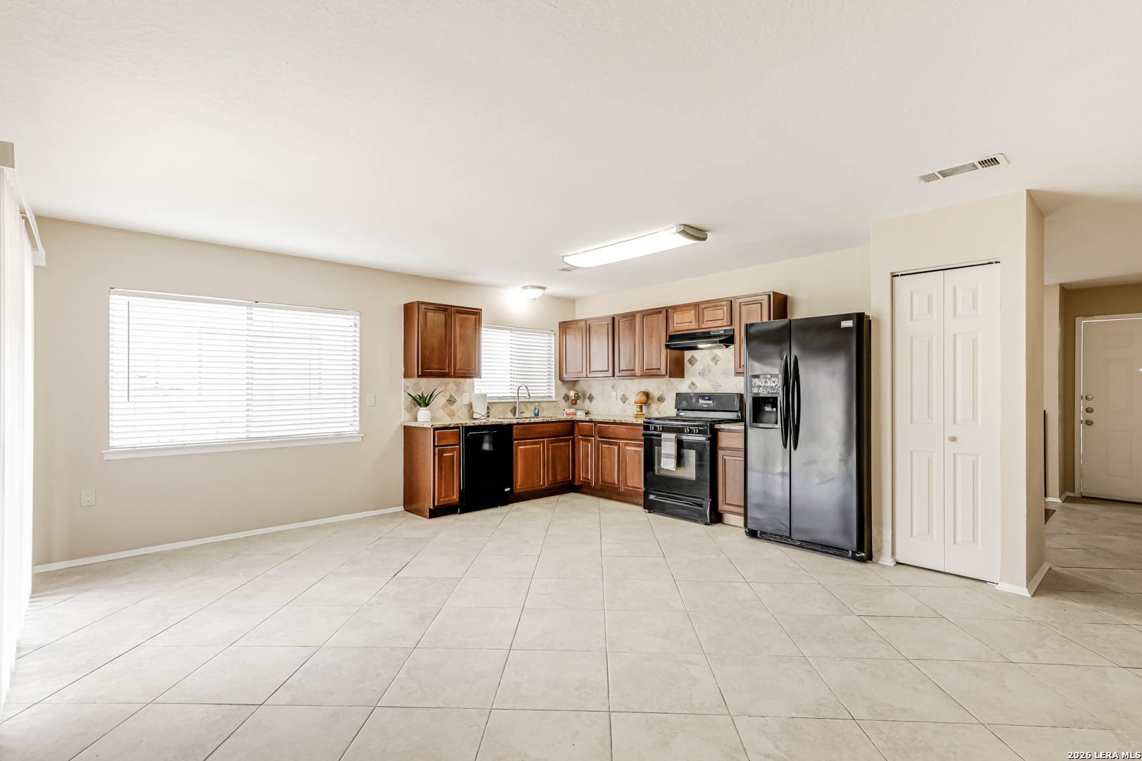 112 Friendswood Path Universal City, TX 78148 - Photo 8 of 31 a kitchen with stainless steel appliances a refrigerator and a sink