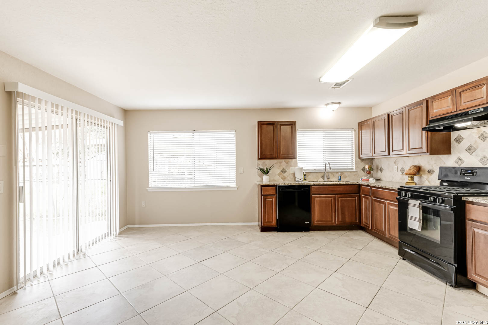 112 Friendswood Path Universal City, TX 78148 - Photo 9 of 31 a large kitchen with stainless steel appliances granite countertop a stove a sink and a microwave