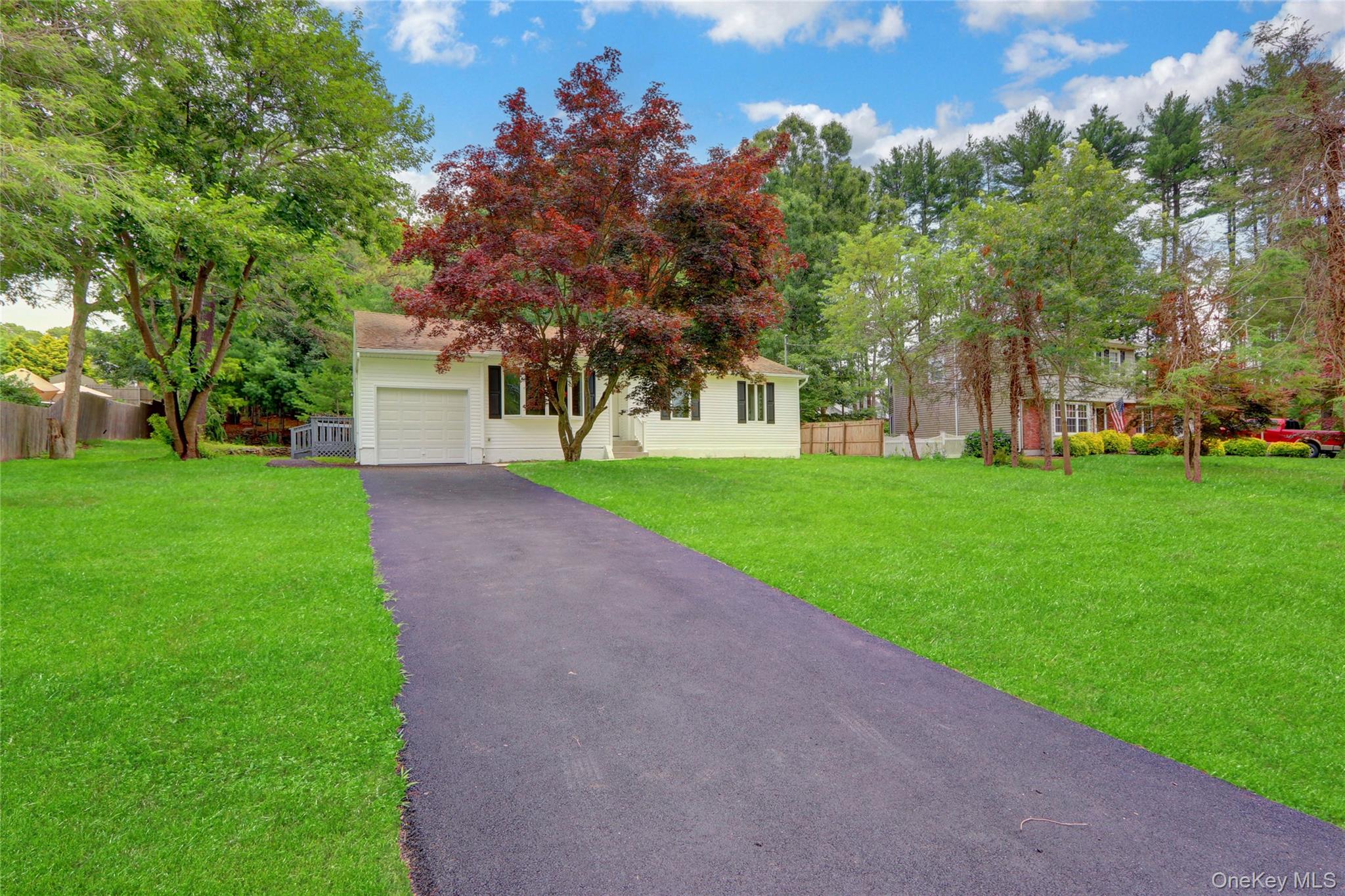 181 Wading River Hollow Road Ridge, NY 11961 - Photo 2 of 24 a front view of a house with garden