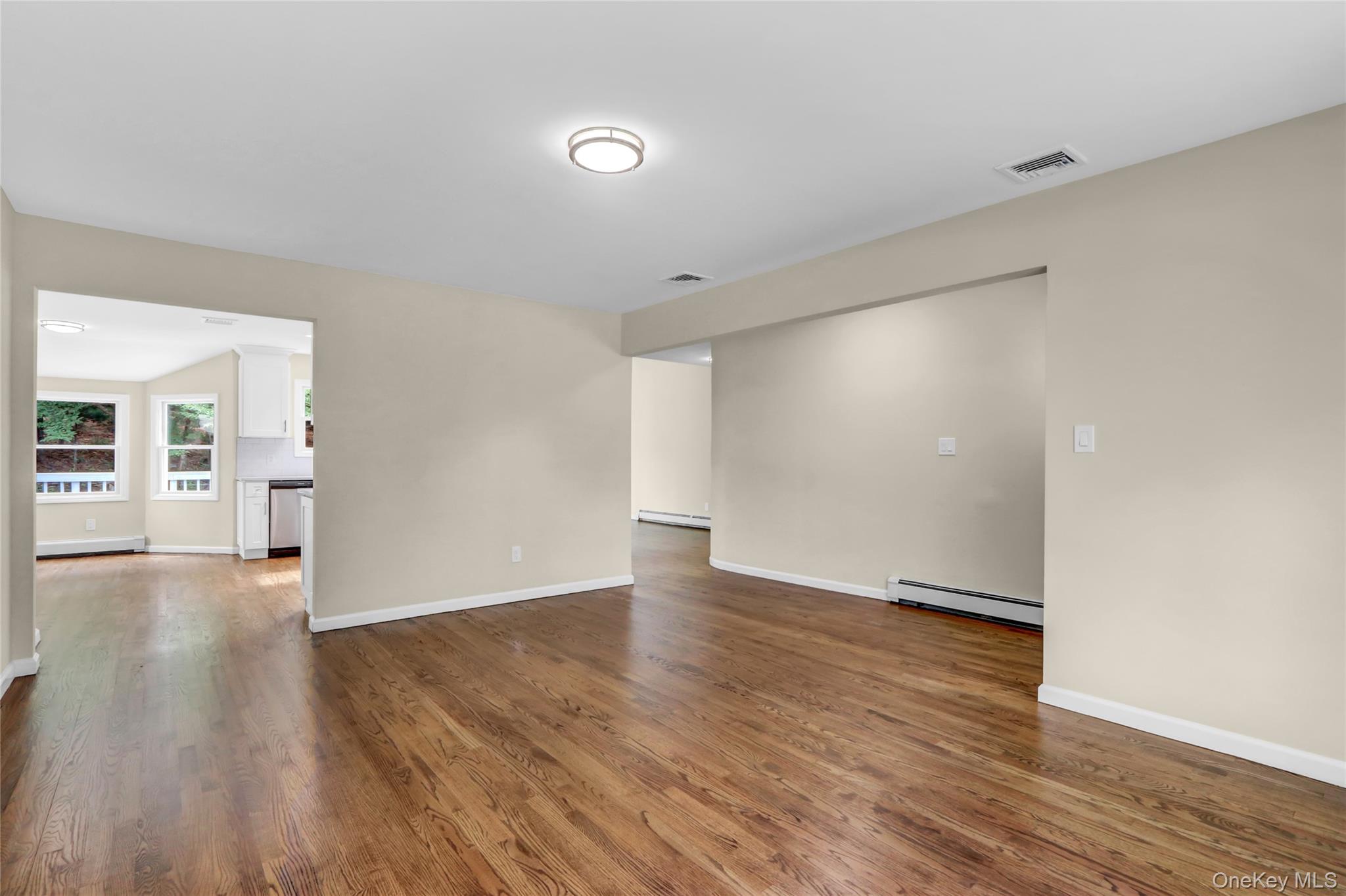 181 Wading River Hollow Road Ridge, NY 11961 - Photo 5 of 24 a view of an empty room with wooden floor