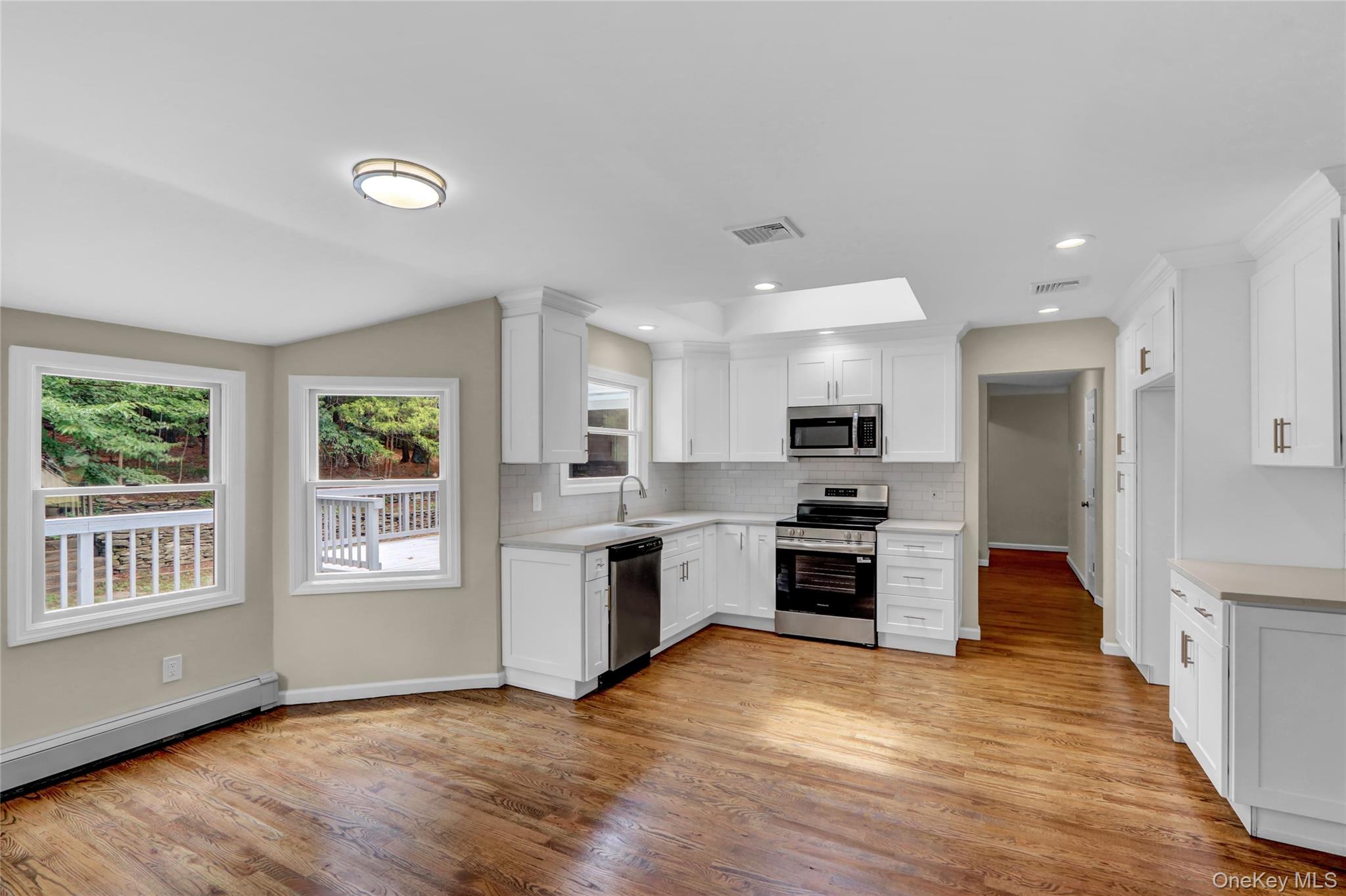 181 Wading River Hollow Road Ridge, NY 11961 - Photo 6 of 24 a large kitchen with stainless steel appliances granite countertop a stove and a refrigerator