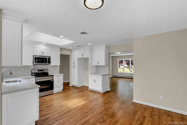 a kitchen with a refrigerator and a stove top oven