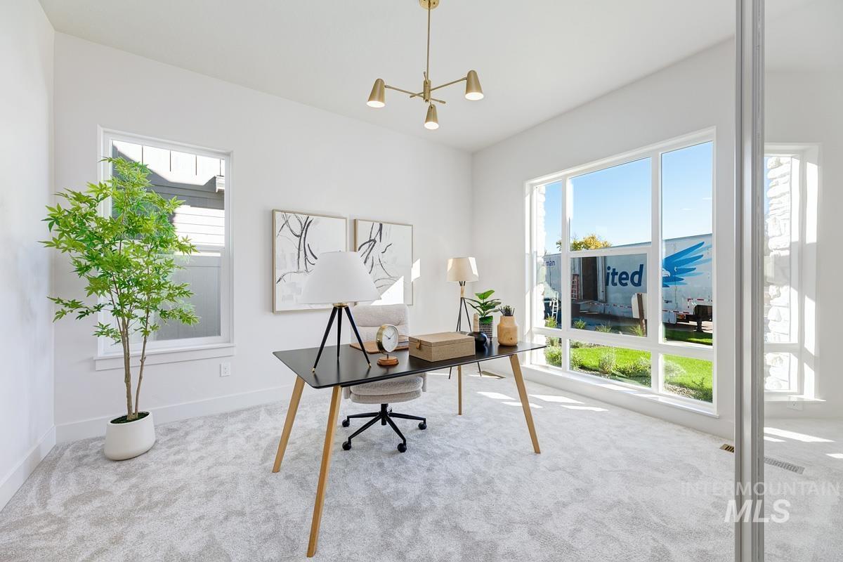 5817 South Gustav Avenue Meridian, ID 83642 - Photo 12 of 33 Light-filled interior space featuring large windows, neutral-toned walls, and plush carpeting