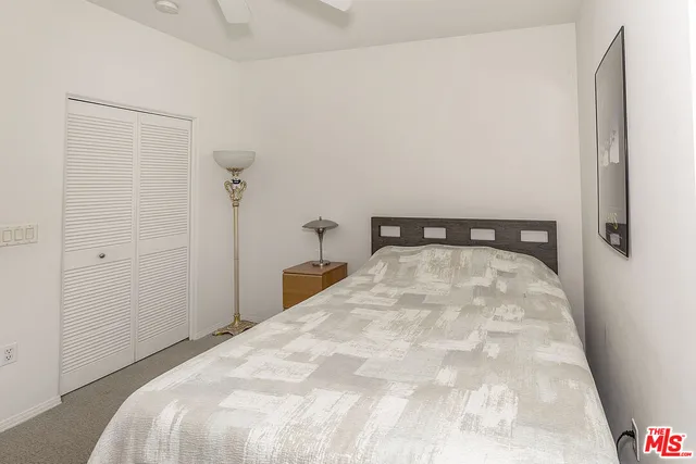 a bedroom with a bed and a mirror