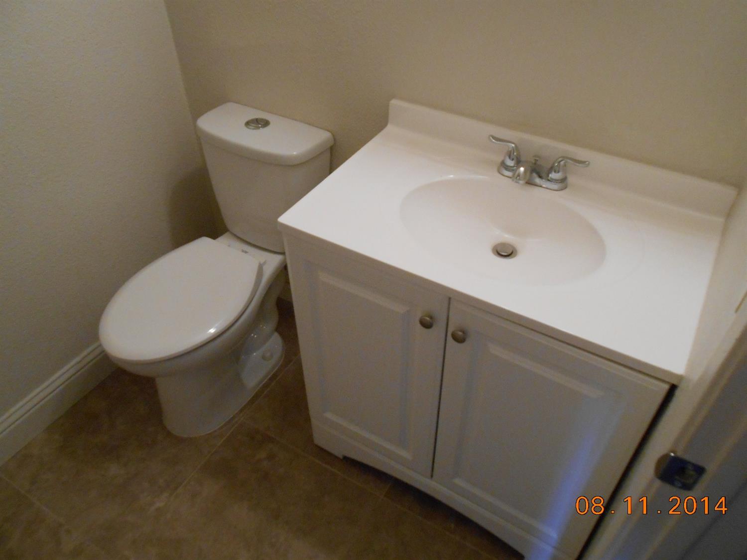 2800 Prescott Road Modesto, CA 95350 - Photo 8 of 13 a white toilet sitting next to a bathroom sink