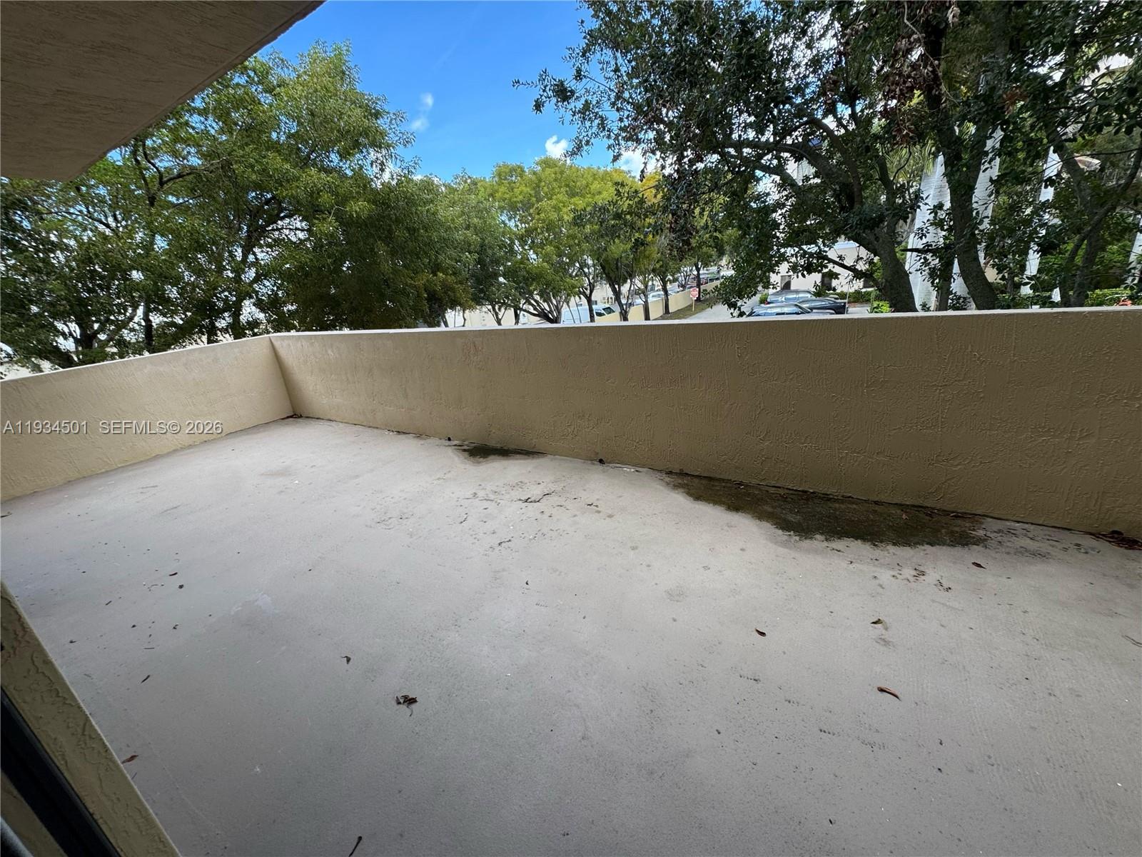 8430 Southwest 8th Street, Unit 201B Miami, FL 33144 - Photo 12 of 14 a view of roof with a tree