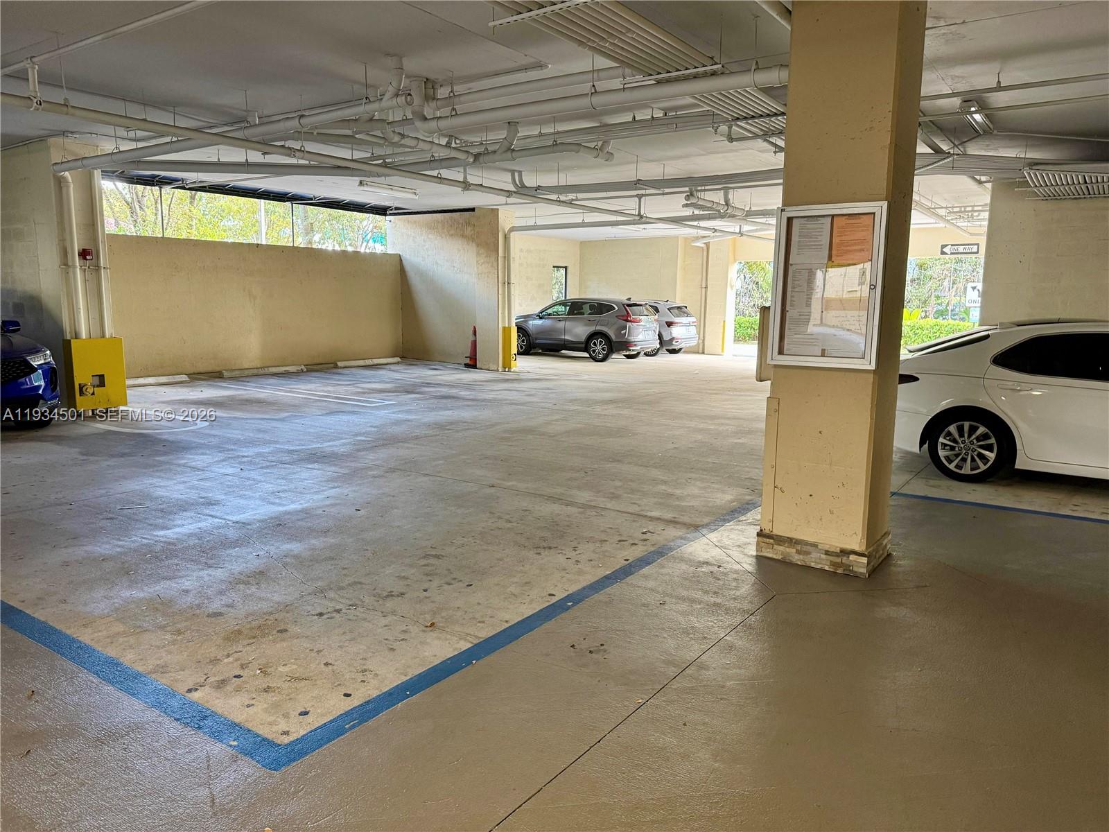 8430 Southwest 8th Street, Unit 201B Miami, FL 33144 - Photo 13 of 14 a view of parking garage with cars