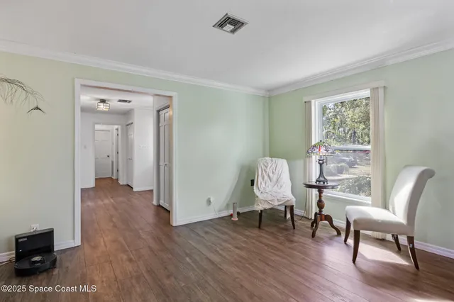 a view of a livingroom with furniture and a window