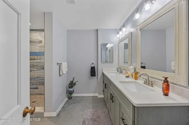 a bathroom with a sink double vanity and a mirror