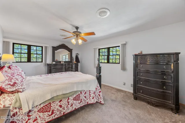 a bedroom with a bed closet and a window