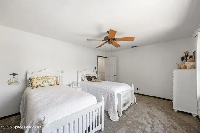 a bedroom with two beds and painted wall