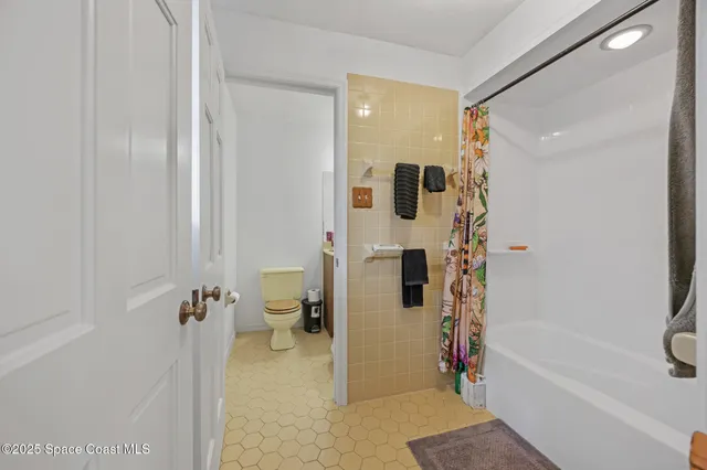 a bathroom with a shower and a toilet