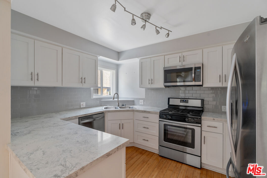 a kitchen with a sink stove and microwave