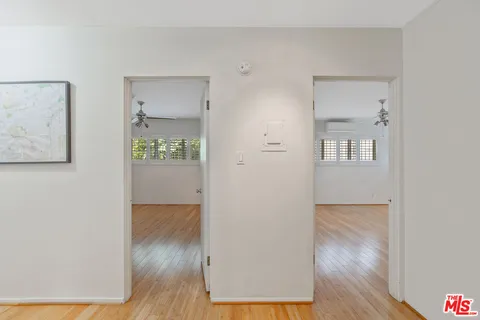 a view of a room with wooden floor and white walls