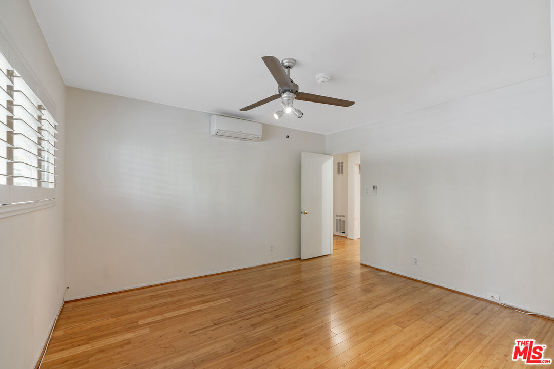 2030 North Vermont Avenue, Unit 6 Los Angeles, CA 90027 - Photo 16 of 25 a view of a room with wooden floor and white walls