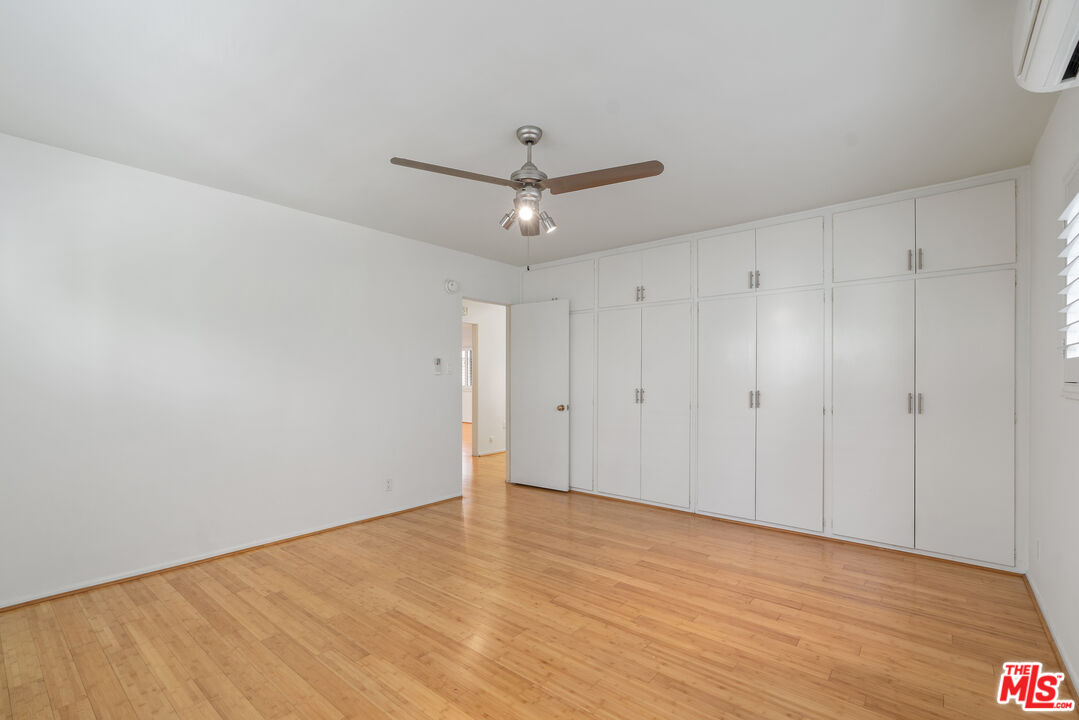 2030 North Vermont Avenue, Unit 6 Los Angeles, CA 90027 - Photo 18 of 25 a view of a room with wooden floor and a ceiling fan