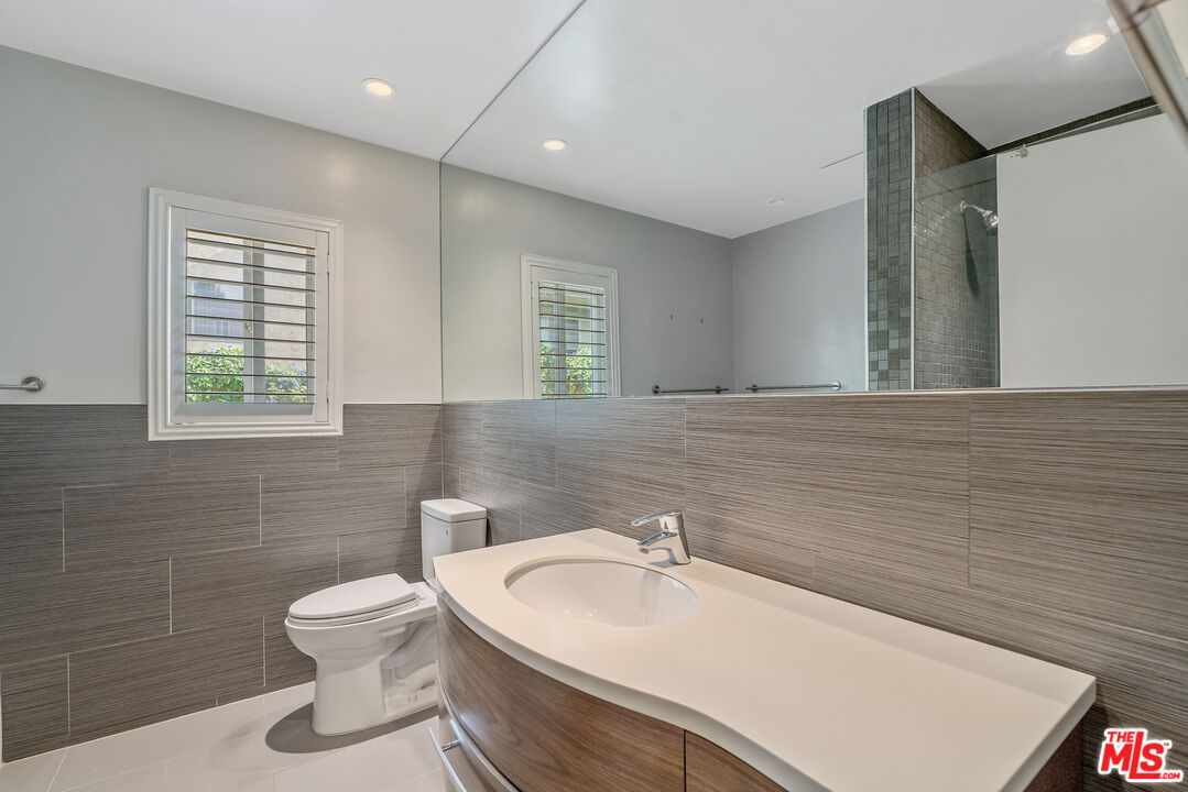2030 North Vermont Avenue, Unit 6 Los Angeles, CA 90027 - Photo 19 of 25 a bathroom with a sink a toilet and mirror